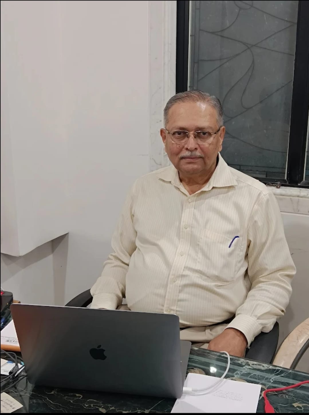 A professional portrait of Dr. B.G. Daptardar, the founder of Sanjeevanee Homeocare.