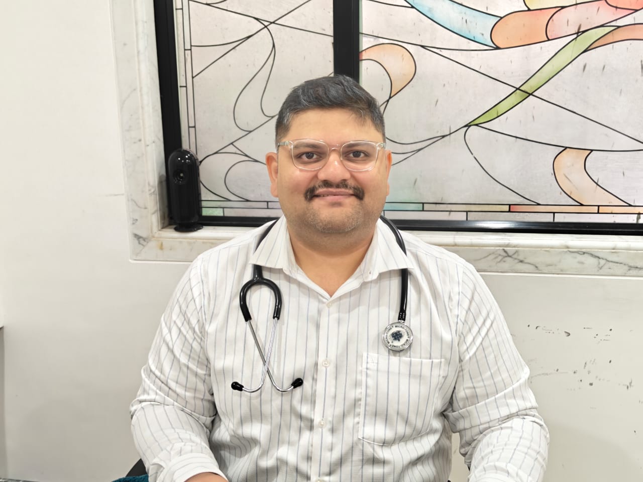 A professional portrait of Dr. Nandan Daptardar of Sanjeevanee Homeocare.